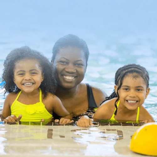 A woman and two girls in the pool