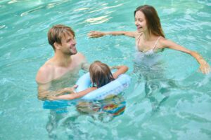 A family swimming in the pool together